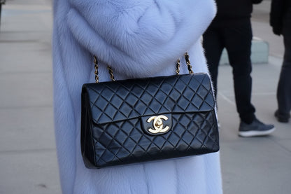 1990s Chanel Jumbo Classic Flap in Black Lambskin with 24kt gold plated hardware.