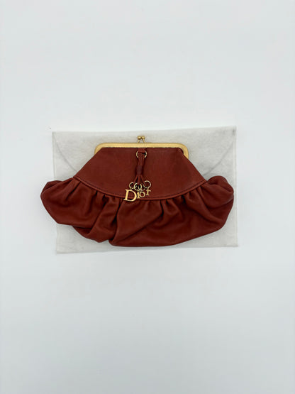 Christian Dior Burnt Orange Lambskin Kiss Lock Clutch with Gold Hardware and Charm.