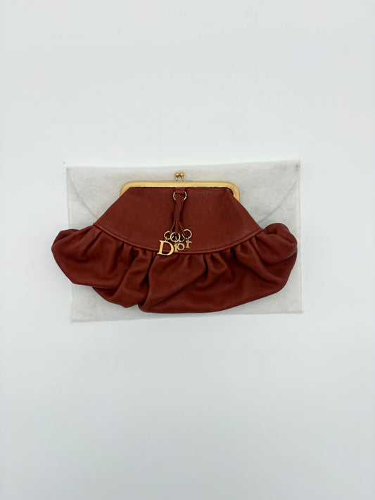 Christian Dior Burnt Orange Lambskin Kiss Lock Clutch with Gold Hardware and Charm.