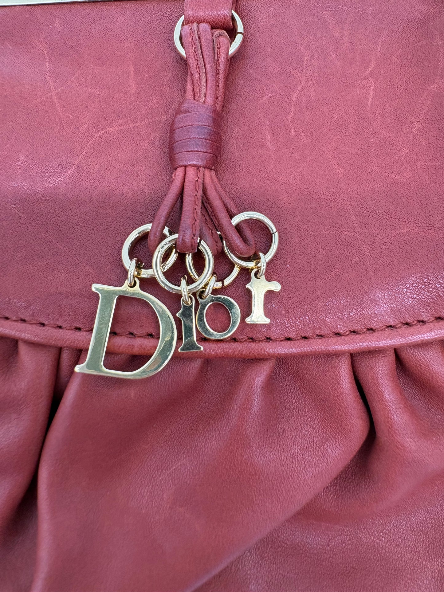Christian Dior Burnt Orange Lambskin Kiss Lock Clutch with Gold Hardware and Charm.