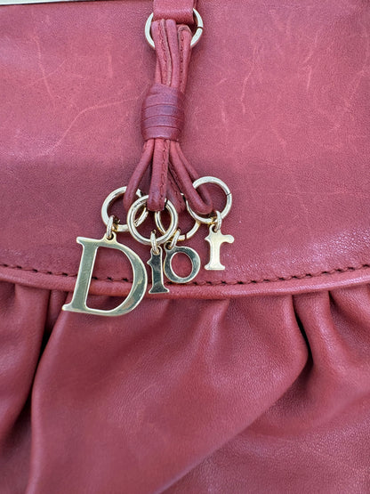 Christian Dior Burnt Orange Lambskin Kiss Lock Clutch with Gold Hardware and Charm.