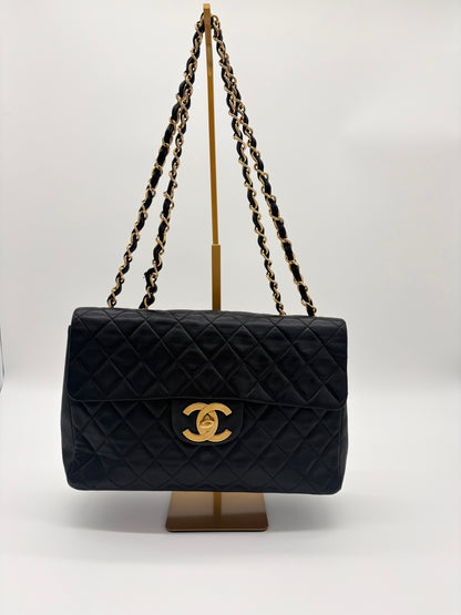 1990s Chanel Jumbo Classic Flap in Black Lambskin with 24kt gold plated hardware.