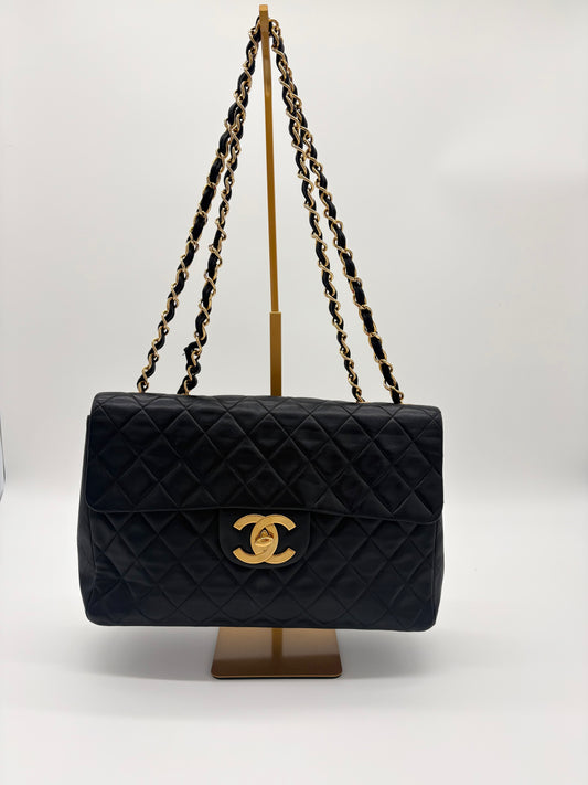 1990s Chanel Jumbo Classic Flap in Black Lambskin with 24kt gold plated hardware.