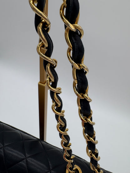 1990s Chanel Jumbo Classic Flap in Black Lambskin with 24kt gold plated hardware.