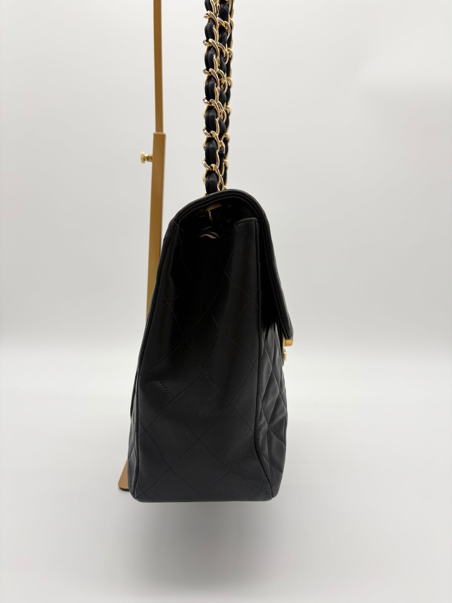 1990s Chanel Jumbo Classic Flap in Black Lambskin with 24kt gold plated hardware.