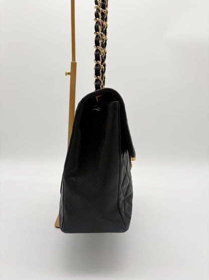 1990s Chanel Jumbo Classic Flap in Black Lambskin with 24kt gold plated hardware.