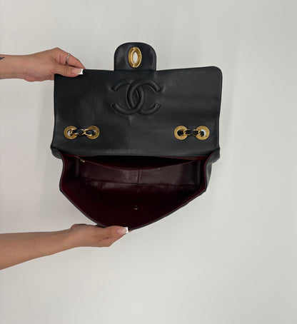 1990s Chanel Jumbo Classic Flap in Black Lambskin with 24kt gold plated hardware.