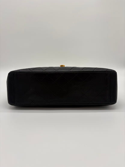 1990s Chanel Jumbo Classic Flap in Black Lambskin with 24kt gold plated hardware.