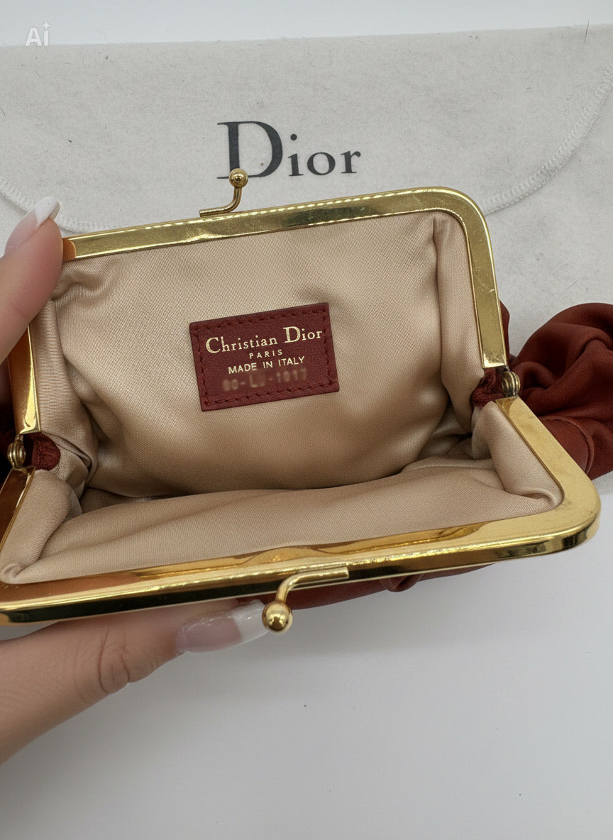 Christian Dior Burnt Orange Lambskin Kiss Lock Clutch with Gold Hardware and Charm.